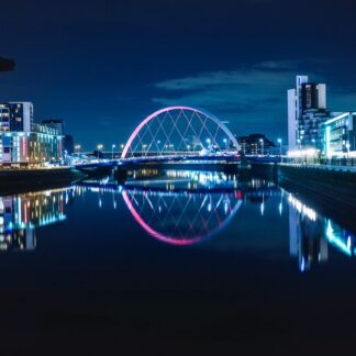 Night view of the Clyde Arc or Squinty Bridge from the East and river Clyde, Glasgow, Scotland
