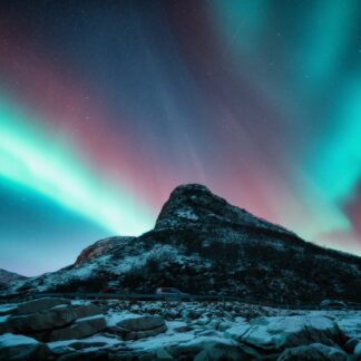 Northern lights and snowy mountains at night. Aurora borealis